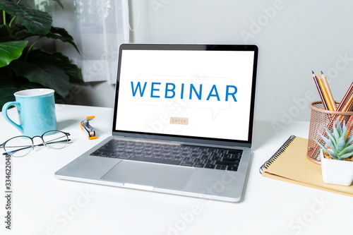 Work From Home with laptop computer for online training webinars. E-learning browsing connection and cloud online technology webcast concept. Laptop mockup with clipping path on screen.