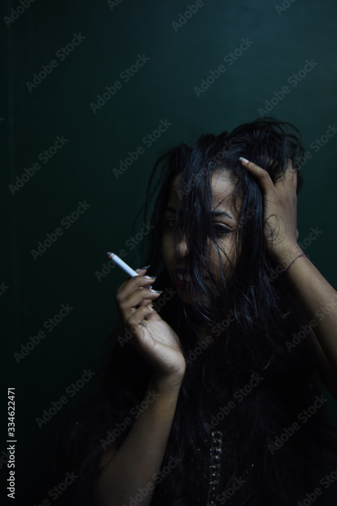 Obraz premium Sexy black woman smoking a cigarette 