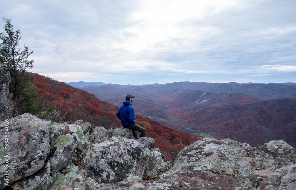 man sitting enjoying the mountains