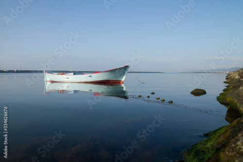 Fototapeta Naklejka Na Ścianę i Meble -  small red blue fishing boat in port