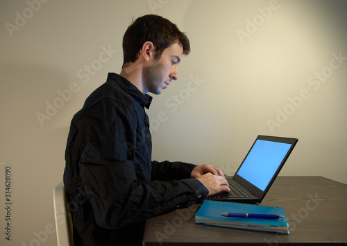 Working from home with a laptop and a notebook.