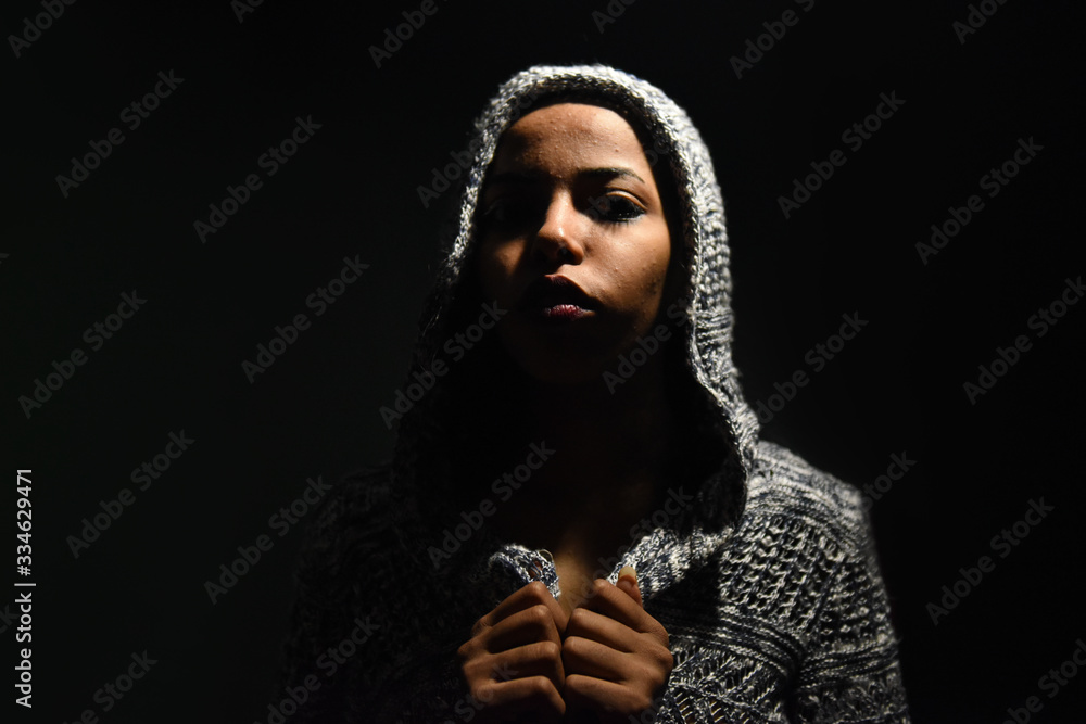 Close up Studio portrait of beautiful young african woman , Low key face shot of elegant girl looking at camera against dark background.
Close up Studio portrait of beautiful young african woman , Low key face shot of elegant girl looking at camera against dark background.