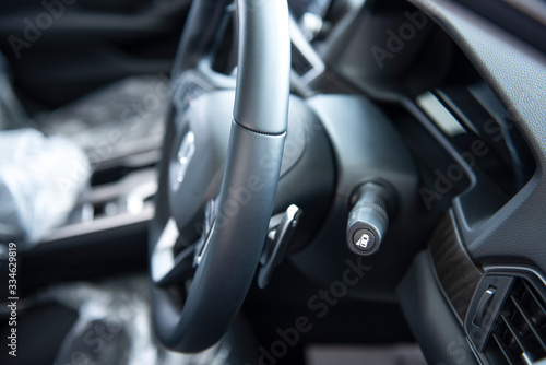 New cars in the luxury car interior showroom Steering wheel, gear lever and control panel