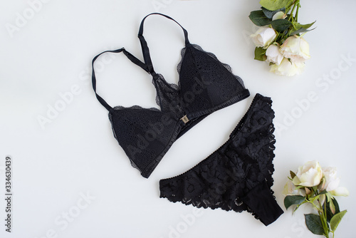 Black woman bra with bouquet of roses on white background.