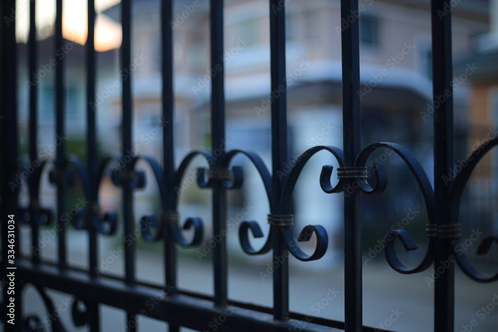 lock down, stay at home and business closed concepts. close up image of fence made of iron cast metal rods. lock down, stay at home and business closed concepts. close up image of fence made of iron cast metal rods.