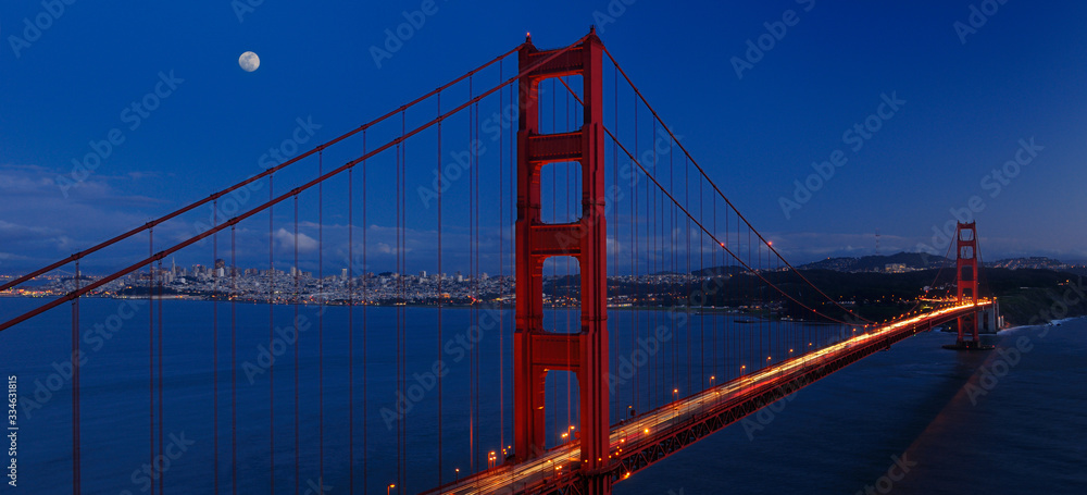 Panorama of Golden Gate Bridge and San Francisco skyline at twilight with rising moon Panorama of Golden Gate Bridge and San Francisco skyline at twilight with rising moon