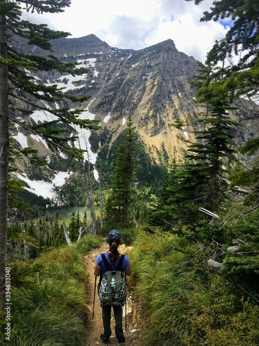 Hiking the rocky terrain of the Crypt Lake Trail, a steep ascent to Crypt Lake including walking a long the very edge of a mountain.  The hike is in Waterton Lakes National Park in Alberta, Canada