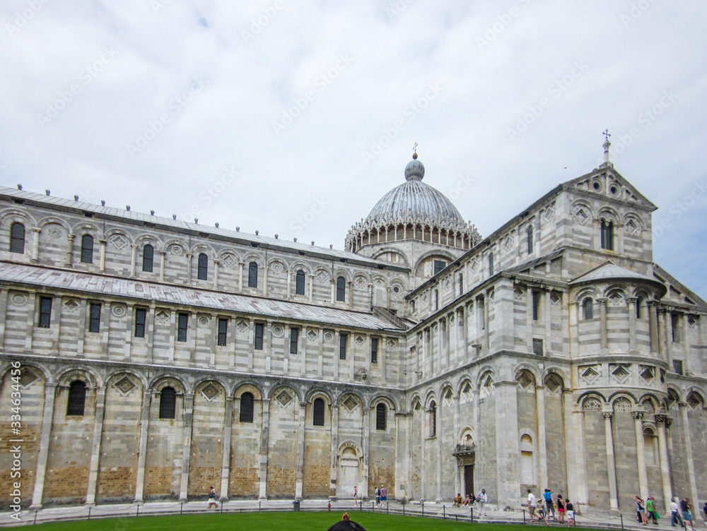 A front shot of the Pisa Cathedral with tourists