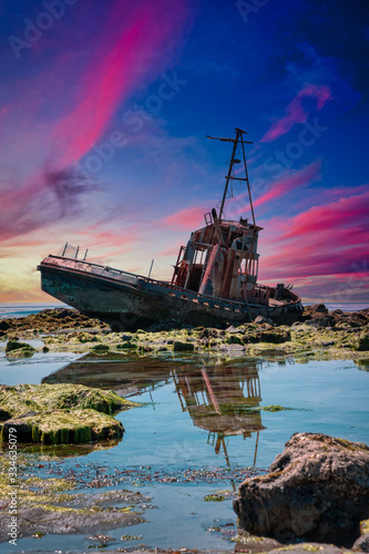 Shipwreck at low tide and sunset