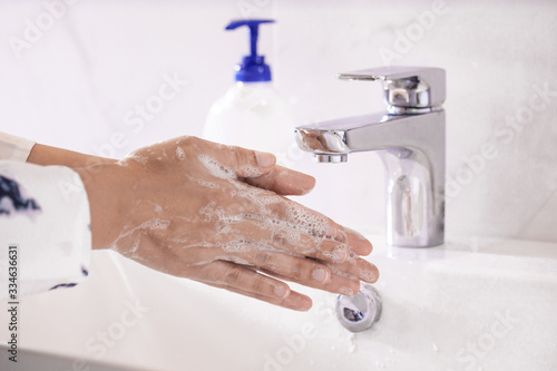 Women washing hands with antibacterial soap sanitizer or alcohol gel for corona covid-19 virus prevention. Hygiene to stop spreading of germs and bacteria and avoid infections corona covid-19 virus.
