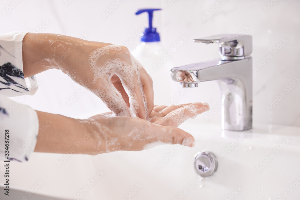 Women washing hands with antibacterial soap sanitizer or alcohol gel for corona covid-19 virus prevention. Hygiene to stop spreading of germs and bacteria and avoid infections corona covid-19 virus. Women washing hands with antibacterial soap sanitizer or alcohol gel for corona covid-19 virus prevention. Hygiene to stop spreading of germs and bacteria and avoid infections corona covid-19 virus.