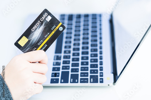 Woman hands holding a credit card for online shopping