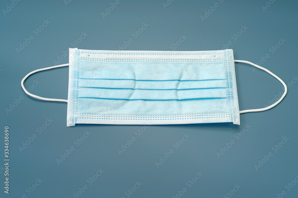 Sanitary napkin mask for preventing spreading and respiratory infections isolated on blue pastel background, Stop Coronavirus Covid-19 concept. Sanitary napkin mask for preventing spreading and respiratory infections isolated on blue pastel background, Stop Coronavirus Covid-19 concept.