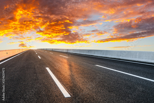 Asphalt highway road and sky sunset clouds landscape. © ABCDstock