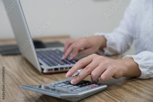 Closeup shot of woman using a laptop while working from home.