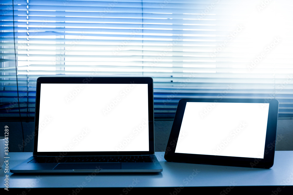 Blank screen laptop and tablet computer on the table Blank screen laptop and tablet computer on the table