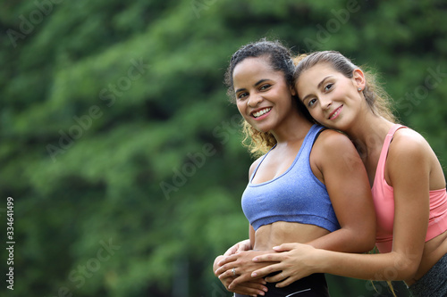 two people or sport women are friend together and exercise or happy relaxing in a green park, partnership or friendship or healthy concept © torsakh