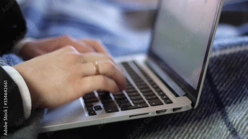 Typing on a laptop keyboard working from home, closeup Typing on a laptop keyboard working from home, closeup