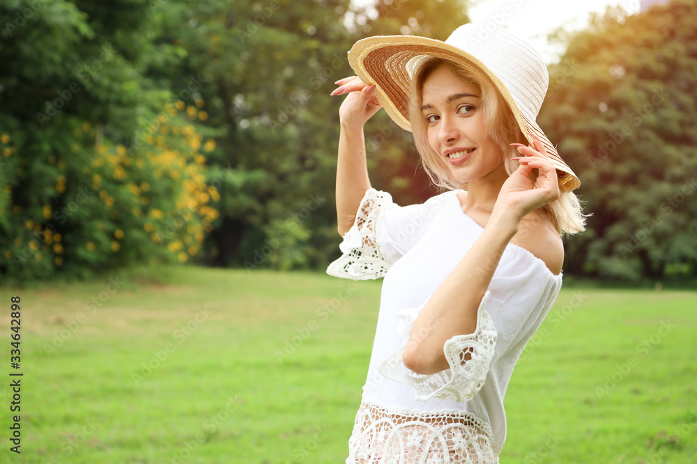 Girl or woman relaxing or playing in the garden park and wear hat and feeling freedom