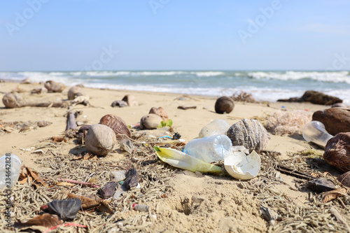 Many Garbage or Plastic bottle waste are on natural beach sand, environment pollution of earth and water animal in ocean 