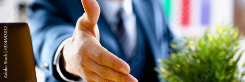 Man in suit and tie give hand as hello in office closeup. Friend welcome mediation offer positive introduction thanks gesture summit participate approval motivation male arm strike bargain © H_Ko