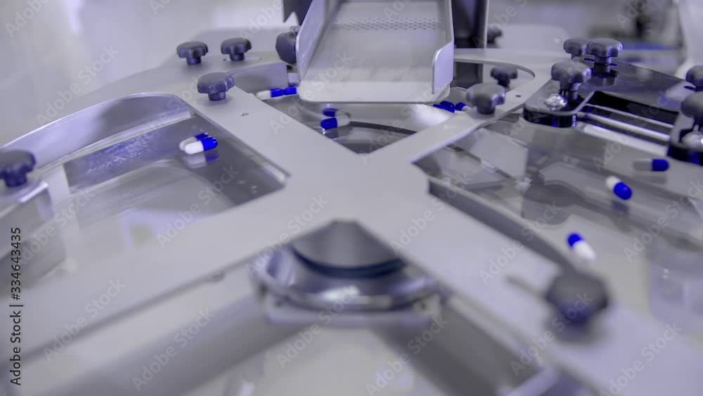Slow motion of Blue pills for COVID-19 treatment spinning on a plate during counting process Slow motion of Blue pills for COVID-19 treatment spinning on a plate during counting process