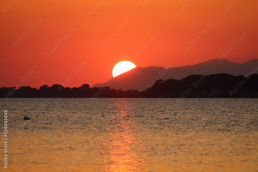 sunset behind the headland with the sea in the foreground sunset behind the headland with the sea in the foreground