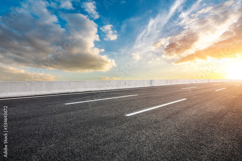 Asphalt highway road and sky sunset clouds landscape.