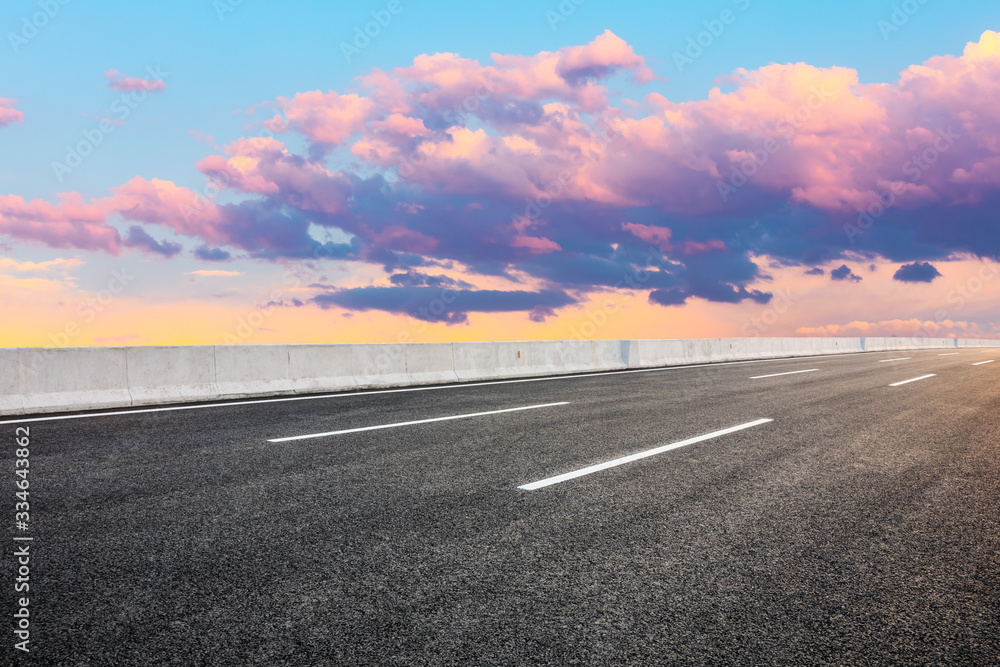 Fototapeta premium Asphalt highway road and sky sunset clouds landscape.