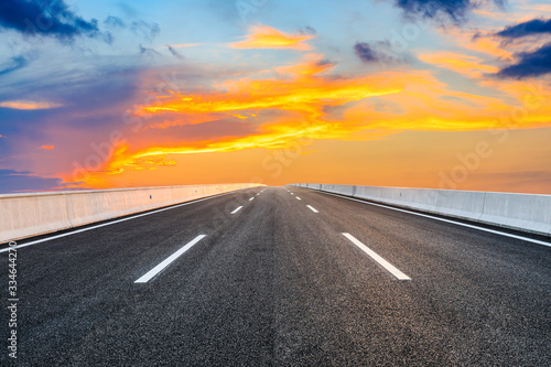 Asphalt highway road and sky sunset clouds landscape. © ABCDstock