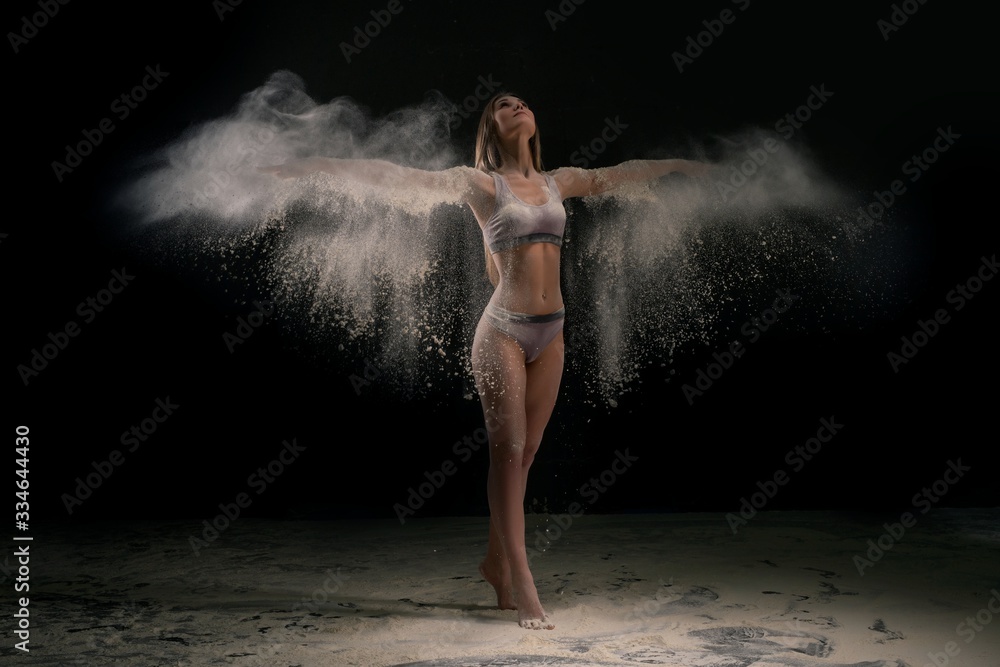 Young woman in white dust cloud shot