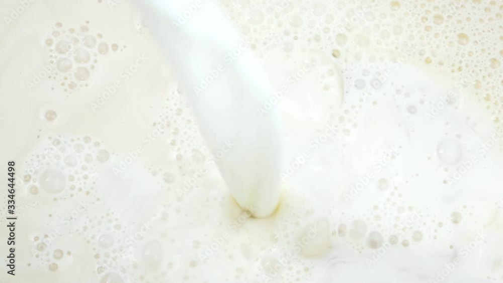 Pink spatula mixing fresh milk in a pot, Closeup Top view Food concept. Pink spatula mixing fresh milk in a pot, Closeup Top view Food concept.