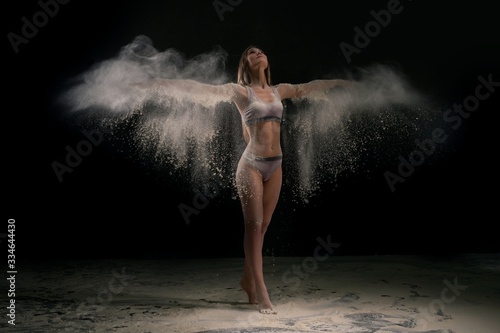 Young woman in white dust cloud shot © Wisky