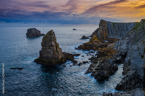 Incredible cliffs on the coast near the village of Liencres before sunrise. Cantabria. Northern coast of Spain