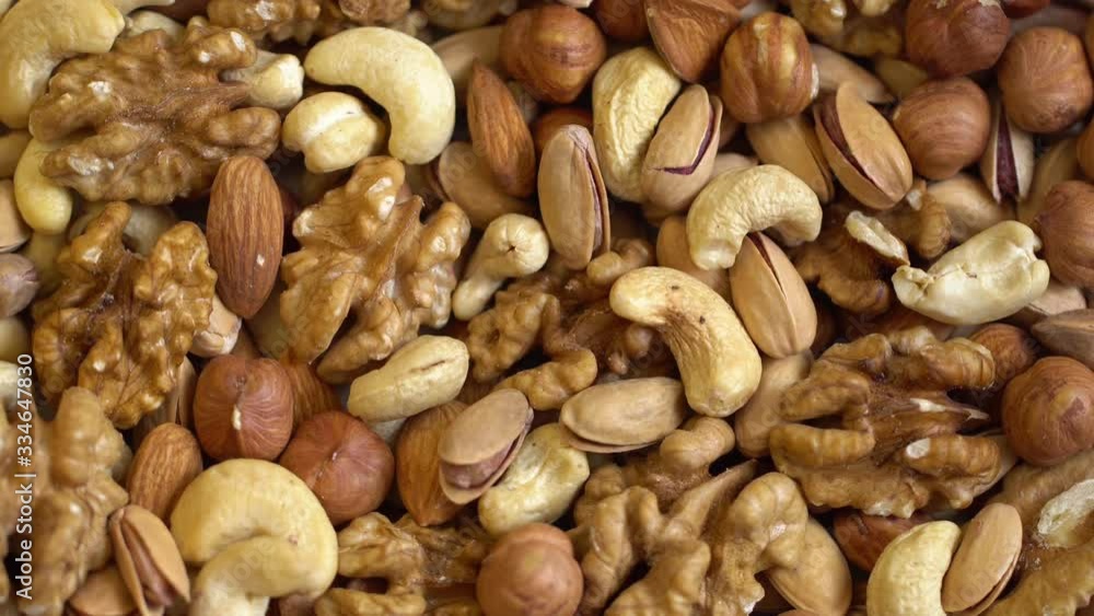 Nuts background with a mixed assortment of seeds with walnut ,hazelnut pistachio almond and cashew as a healthy food symbol and nutritious protein and lifestyle icon. Nuts background with a mixed assortment of seeds with walnut ,hazelnut pistachio almond and cashew as a healthy food symbol and nutritious protein and lifestyle icon.