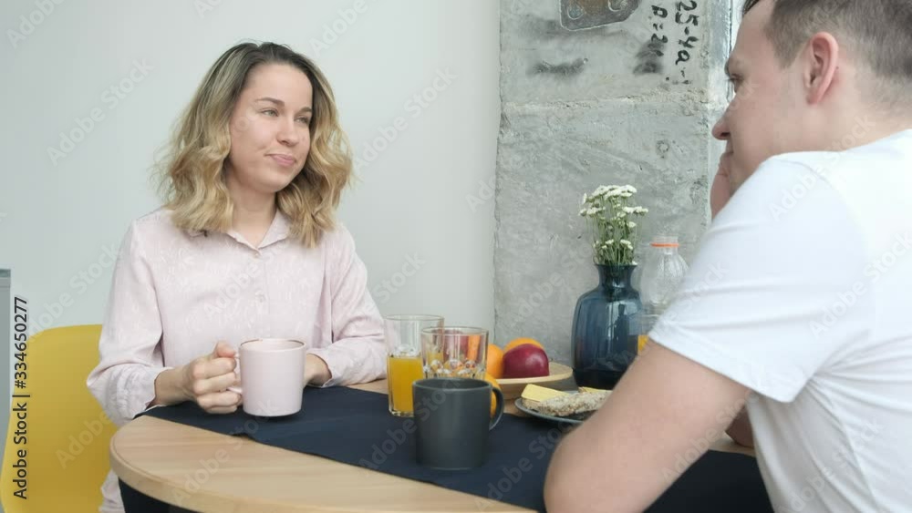Couple eating breakfast early in the morning in the kitchen and having a good time. Couple eating breakfast early in the morning in the kitchen and having a good time.