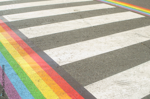 Gay Pride Month. lgbt rainbow on the pedestrian path.  Asfalt on the street, summer day. © AlejandroIvanSuarez