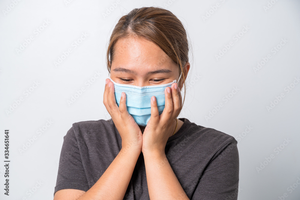 Covid-19 Concept,Asian young woman wearing a hygiene protective mask over her face on White background,Coronavirus Covid-19 and Air pollution pm2.5 concept background. Covid-19 Concept,Asian young woman wearing a hygiene protective mask over her face on White background,Coronavirus Covid-19 and Air pollution pm2.5 concept background.