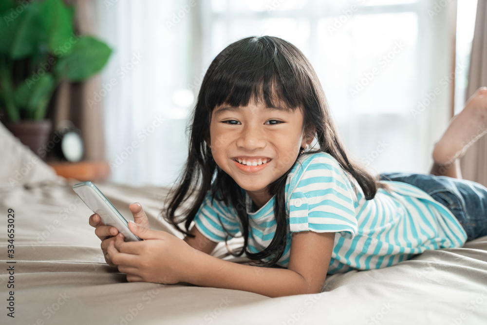 addicted young child using smartphone at home addicted young child using smartphone at home