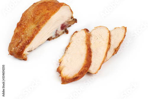 A close up of grilled, sliced chicken breast isolated on white background .
