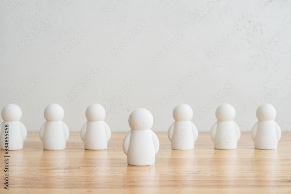 Leader and team on wood table with white wall background and copy space. Leadership and talent management, business strategy, recruitment human resources concept Leader and team on wood table with white wall background and copy space. Leadership and talent management, business strategy, recruitment human resources concept