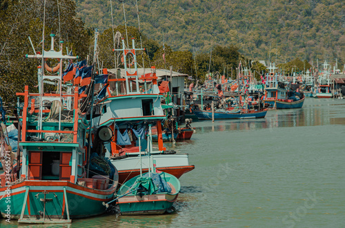 Fishing boat at fisherman village with mountain background.