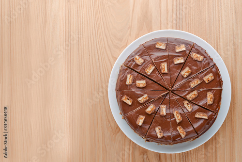 Delicious salted caramel chocolate cake with nuts and vanilla decorated with chocolate pieces