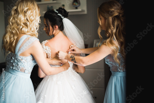 Hands of bridesmaids on bridal dress. Happy marriage and bride at wedding day concept