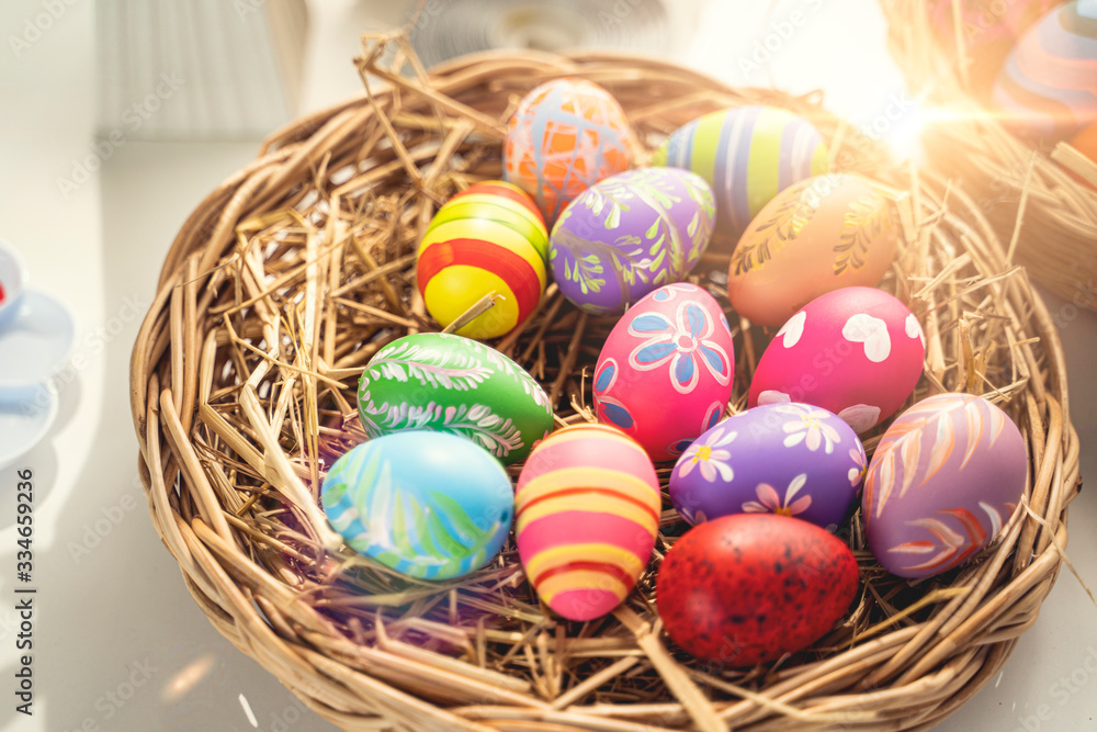close up of many different vibrant colorful piles easter eggs laying on bird nest basket with straw hay, representing decorating and painting eggs to celebrate easter holidays with sunlight reflection close up of many different vibrant colorful piles easter eggs laying on bird nest basket with straw hay, representing decorating and painting eggs to celebrate easter holidays with sunlight reflection