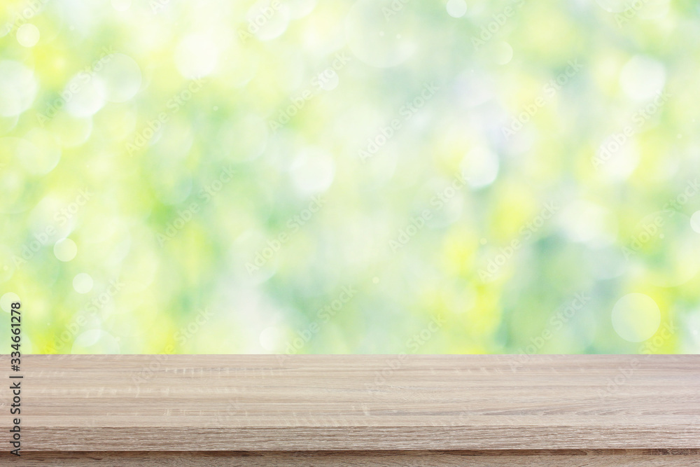 empty wooden table on a blurred green natural background. empty wooden table on a blurred green natural background.