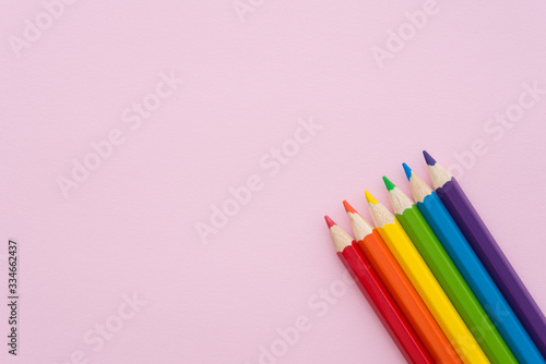 Close up group of color pencils, pen, crayon on pink background with copy space. Child or kid design creativity idea, art, education or back to school concept.