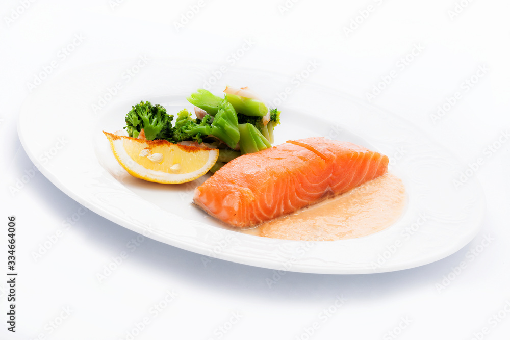 cooked salmon with a side dish of broccoli and Lemon cooked salmon with a side dish of broccoli and Lemon
