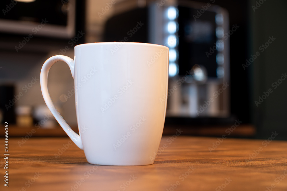 White mug on kitchen background White mug on kitchen background