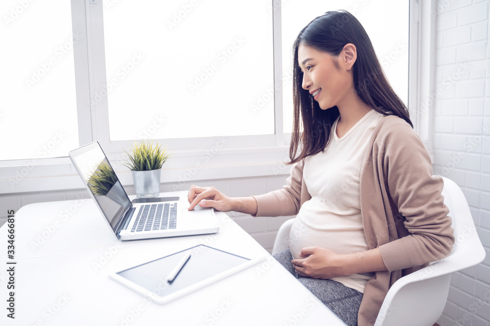 Expectant Person Computer pregnant asian woman hard work, working from home in modern white ...